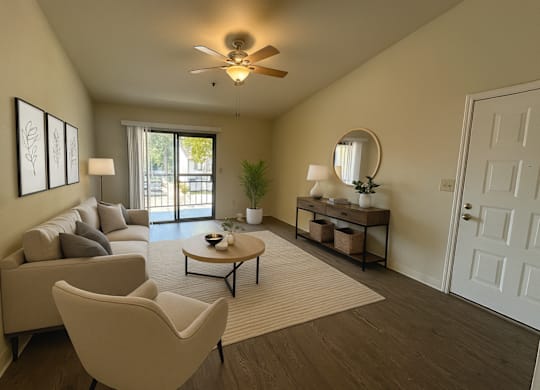 A living room with a couch, chairs, and a coffee table.