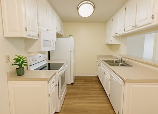 A kitchen with white cabinets and appliances.