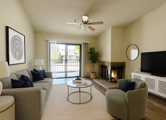 A living room with a grey couch, a coffee table, a fireplace, and a television.