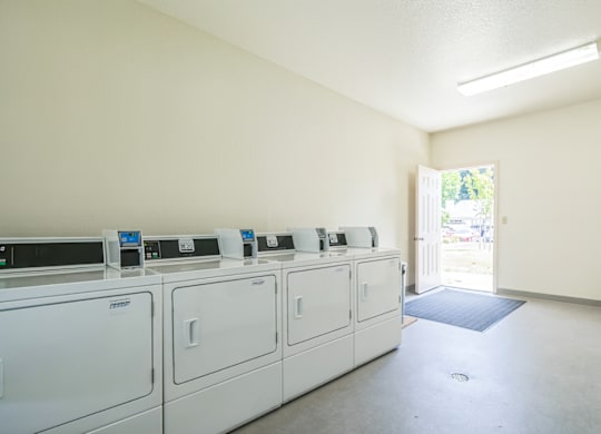 A laundry room with washers and dryers.