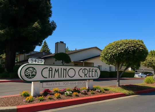 A sign for Camino Creek with a phone number and hours of operation.