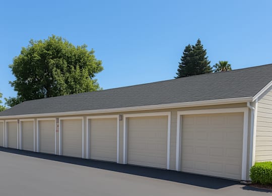 A long row of white garage doors are closed.