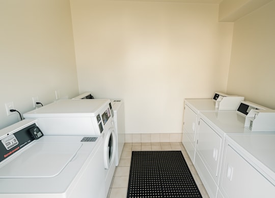 A white washing machine and dryer in a laundry room.