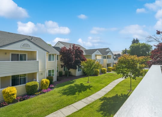A row of houses with a white fence in front.