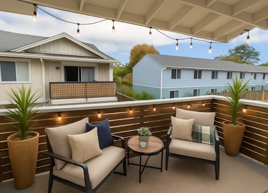 A patio with a couch, chairs, and potted plants.
