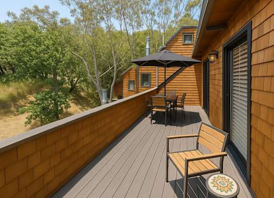 A wooden deck with a bench and a table.