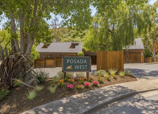 A sign that says Posada West is in front of a building.
