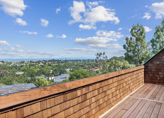 A wooden deck overlooks a cityscape.