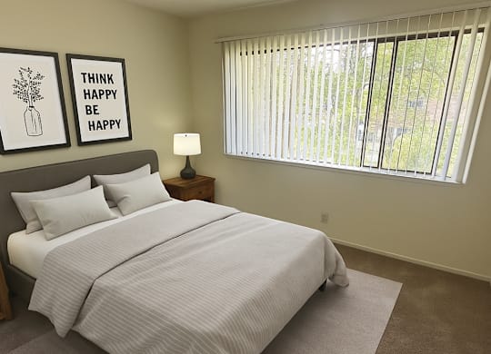 A bedroom with a bed, nightstand, and window with blinds.