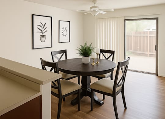 A dining room with a table and chairs.