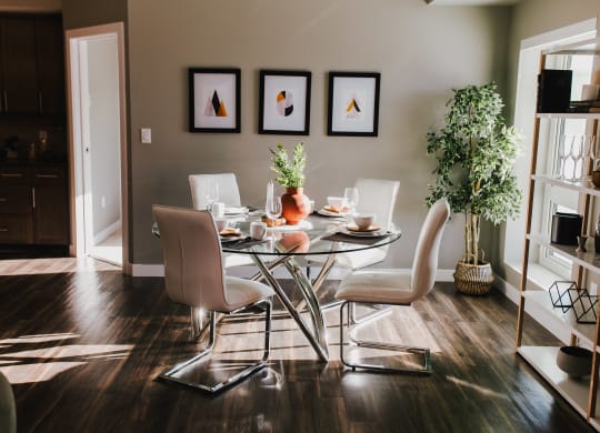a dining room with a glass table and chairs