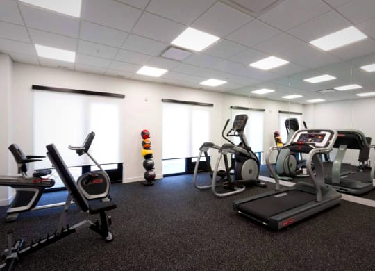 a gym with various exercise equipment in a large room