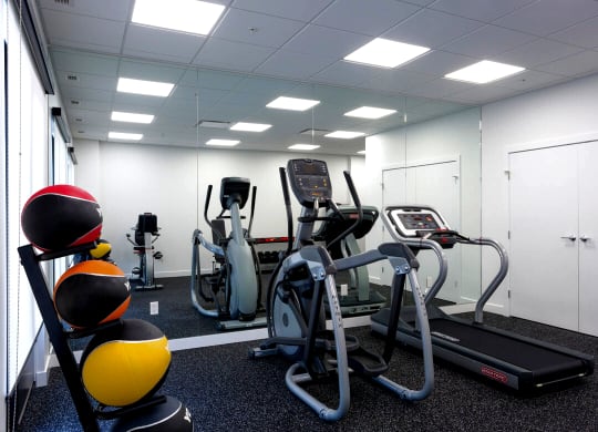 a gym with cardio equipment in a break room