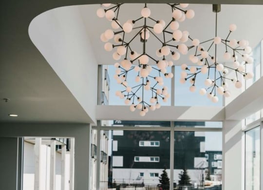 a living room with a couch and a chandelier