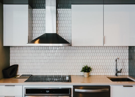 a kitchen with white cabinets and a sink