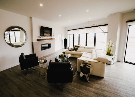 a living room with a couch and a chair and a fireplace