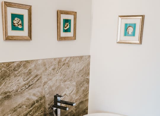a large white bath tub in a bathroom with a shower