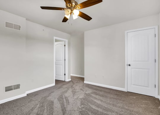 bedroom with grey carpet and ceiling fan natural light