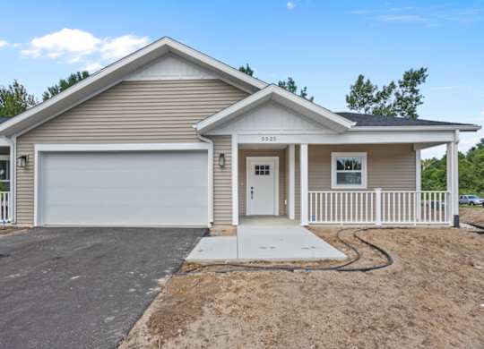 A two-story house with a garage is shown.