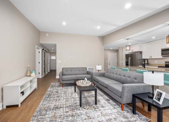 A living room with a grey couch and a coffee table.