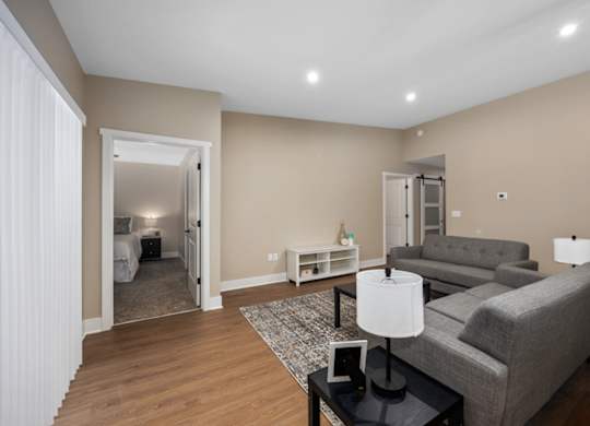 A living room with a grey couch and a black coffee table.