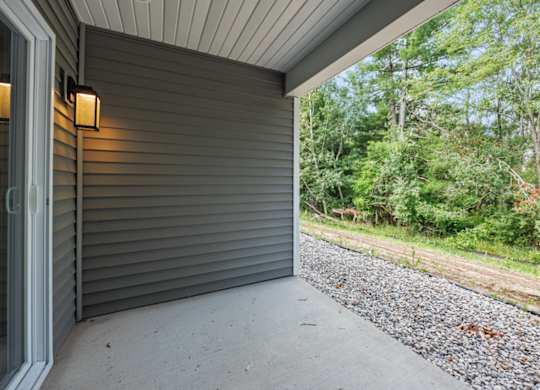 A grey house with a grey wall and a grey floor.