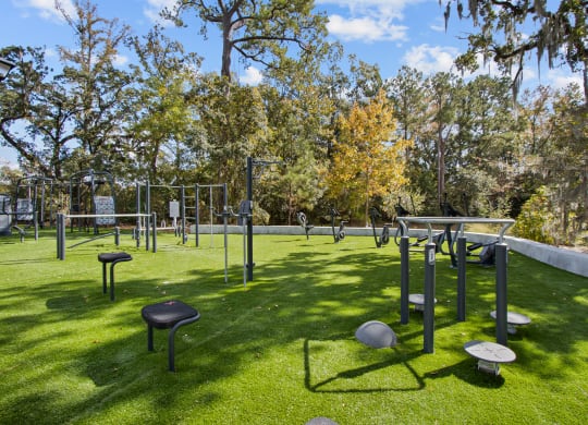 a park with tables and chairs on the grass