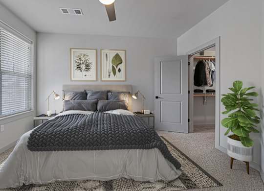 A bedroom with a large bed and a ceiling fan.