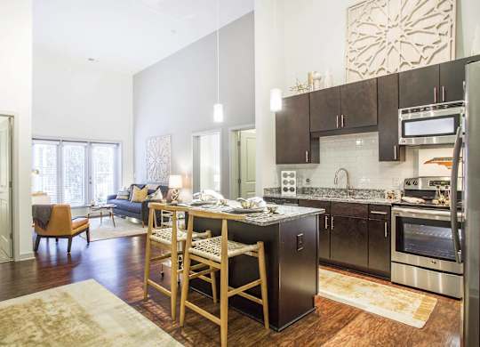 A kitchen with a table and chairs in the middle of the room.