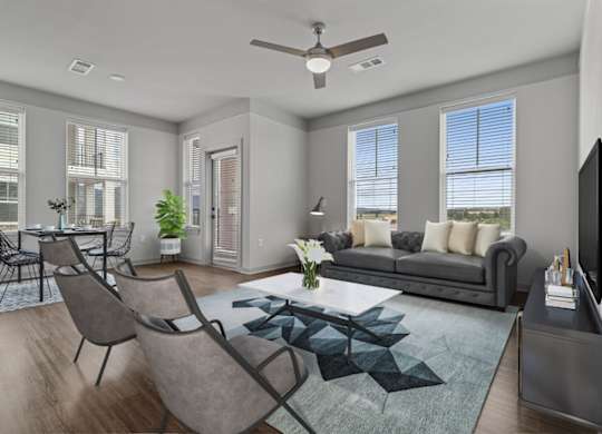 A modern living room with a grey sofa, a coffee table, and a television.