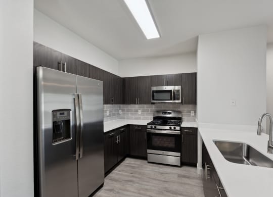 a kitchen with stainless steel appliances and white counter tops