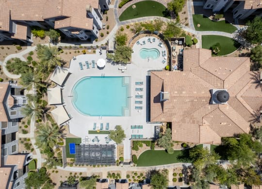 a birds eye view of a mansion with a swimming pool in the backyard