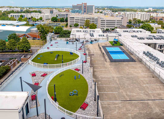 an aerial view of a city with a park and a pool