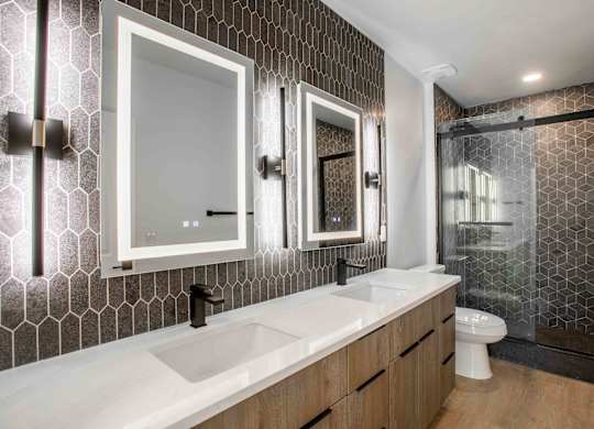 a bathroom with two sinks and a shower and a toilet