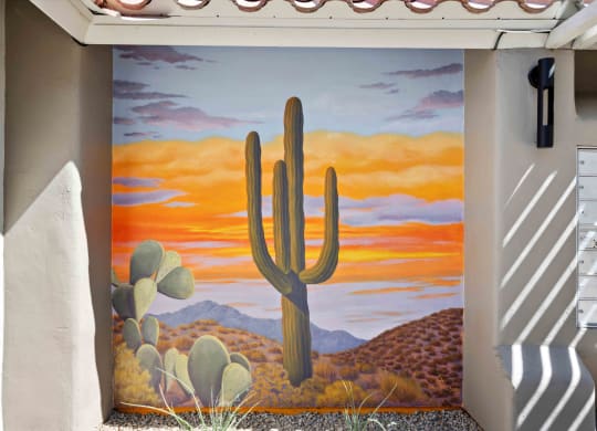 a mural of a saguaro cactus in the desert