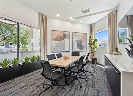 A conference room with a long table and chairs.