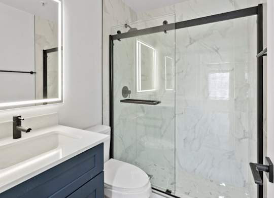 A white sink with a black faucet in a bathroom.
