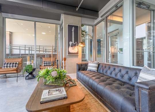 a living room with leather couches and a coffee table