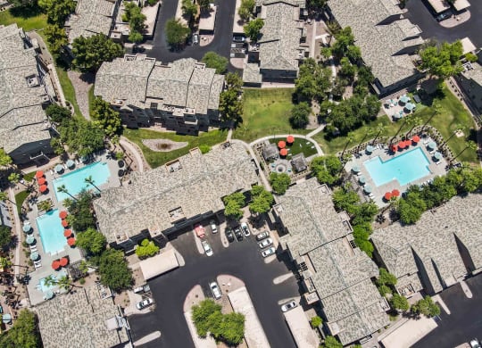 arial view of a neighborhood with lazo apartments and pools