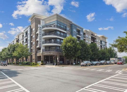 a large apartment building with balconies and a sign on the side of the building that reads