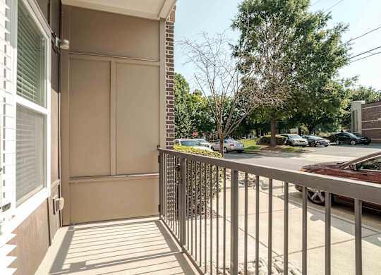 a balcony with a view of a parking lot