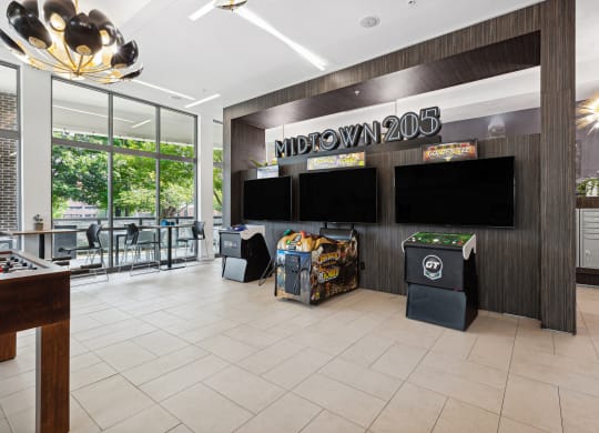 a view of the lobby at midtown 206 with a variety of games on the wall and