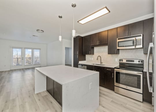 a kitchen with a white island and black cabinets