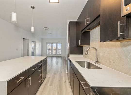 a large kitchen with a sink and counter tops