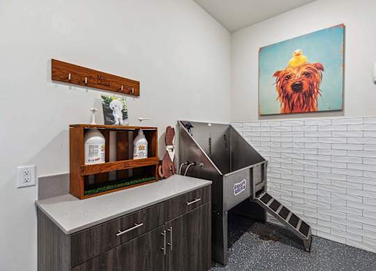 A kitchen with a wooden shelf and a painting of a dog on the wall.