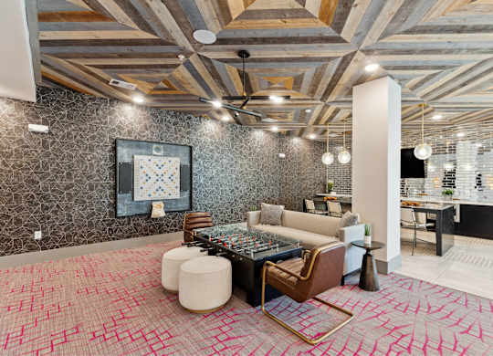 A modern living room with a patterned carpet and a ceiling fan.