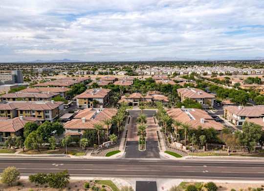A suburban neighborhood with houses and palm trees.