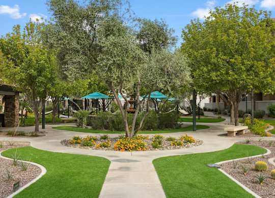 A garden with a circular flower bed in the center and a walking path around it.