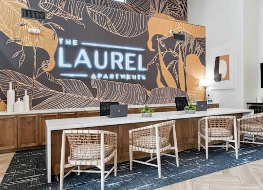 A conference room with a large table and chairs with a backdrop that says