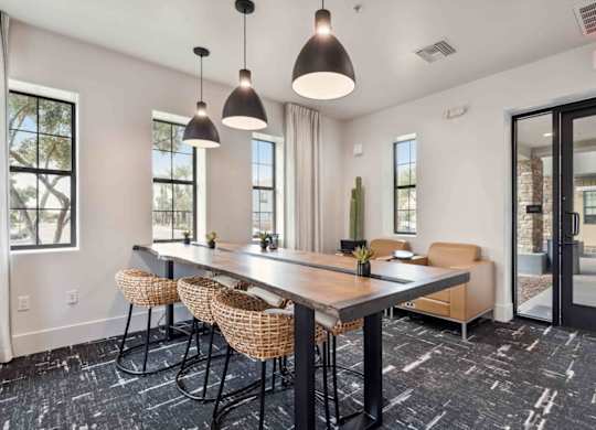 A conference room with a long table and chairs.